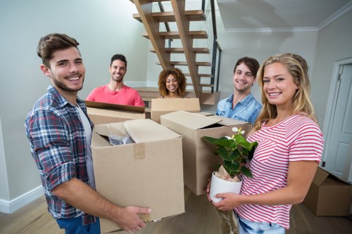 Removal team planning a flat move in Uxbridge with boxes and furniture